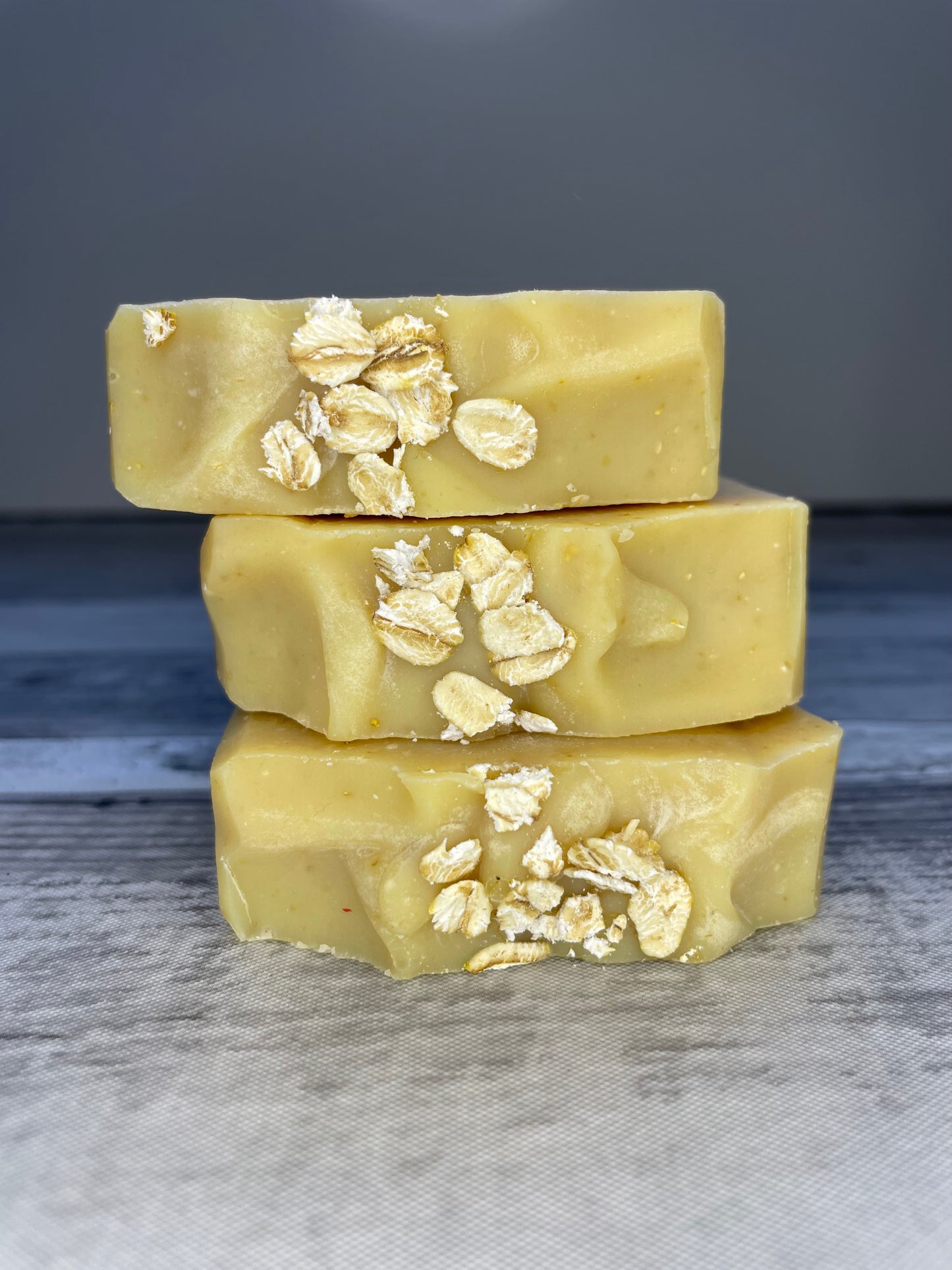 3 honey and oats soaps stacked on top of each other showing the creamy texture of the top