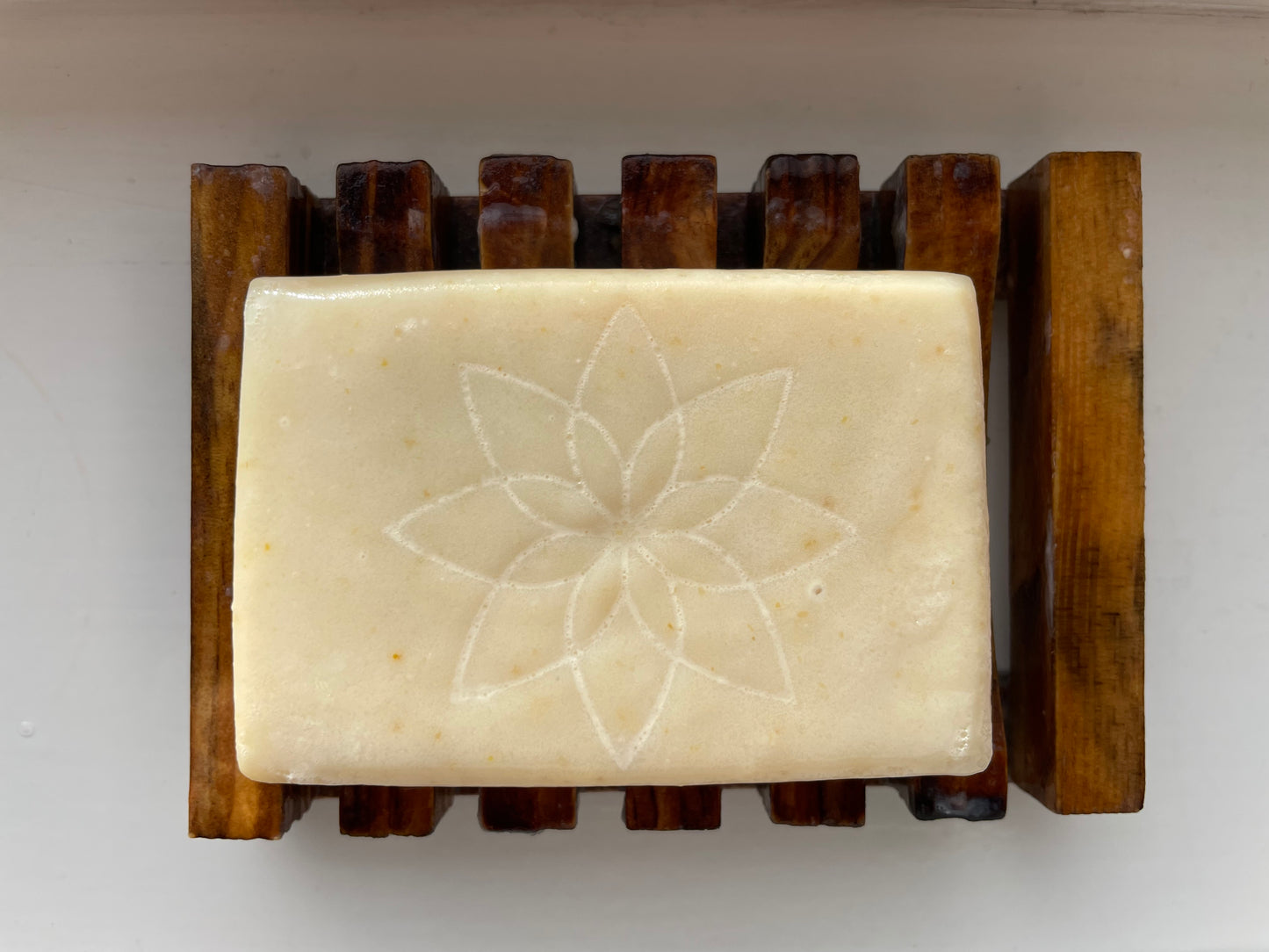 Honey and Oat unscented soap bar, naked, for a natural beauty feeling, on a wooden soap dish